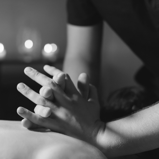 hands crossed over massaging a mans back