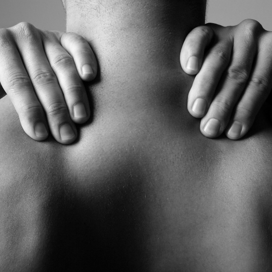 two hands resting on the shoulders of a man